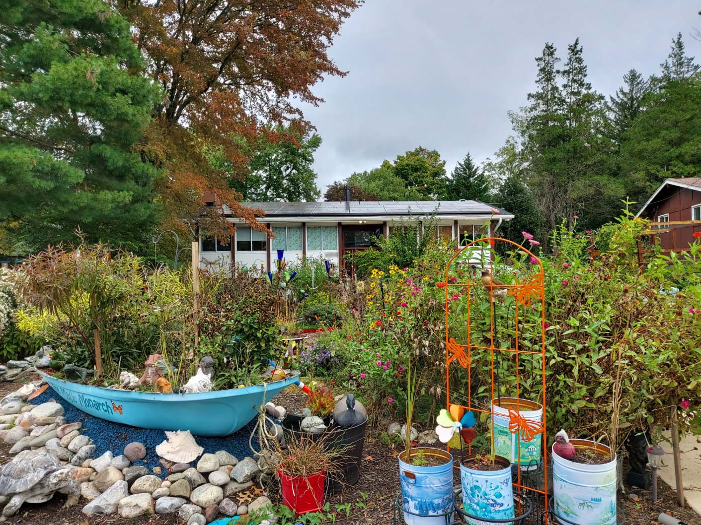 An eclectic landscaped front yard with lots of flowering plants