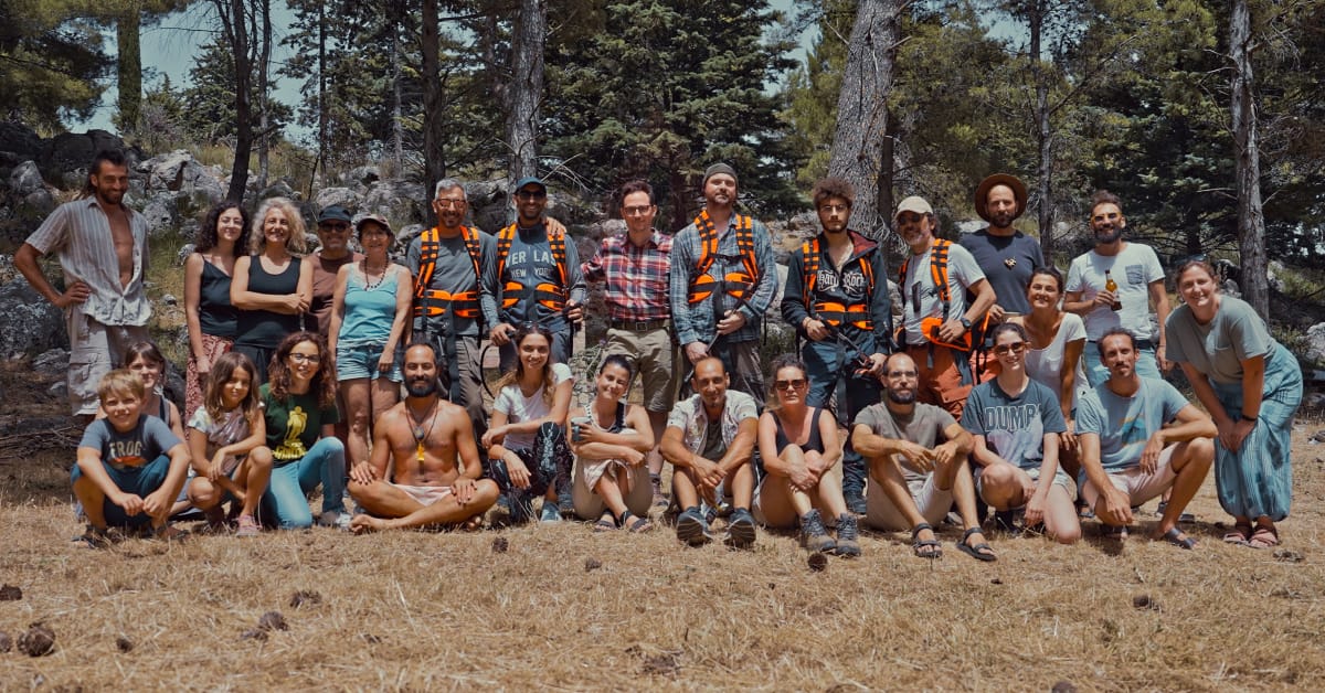 A group of people posing for the camera outdoors